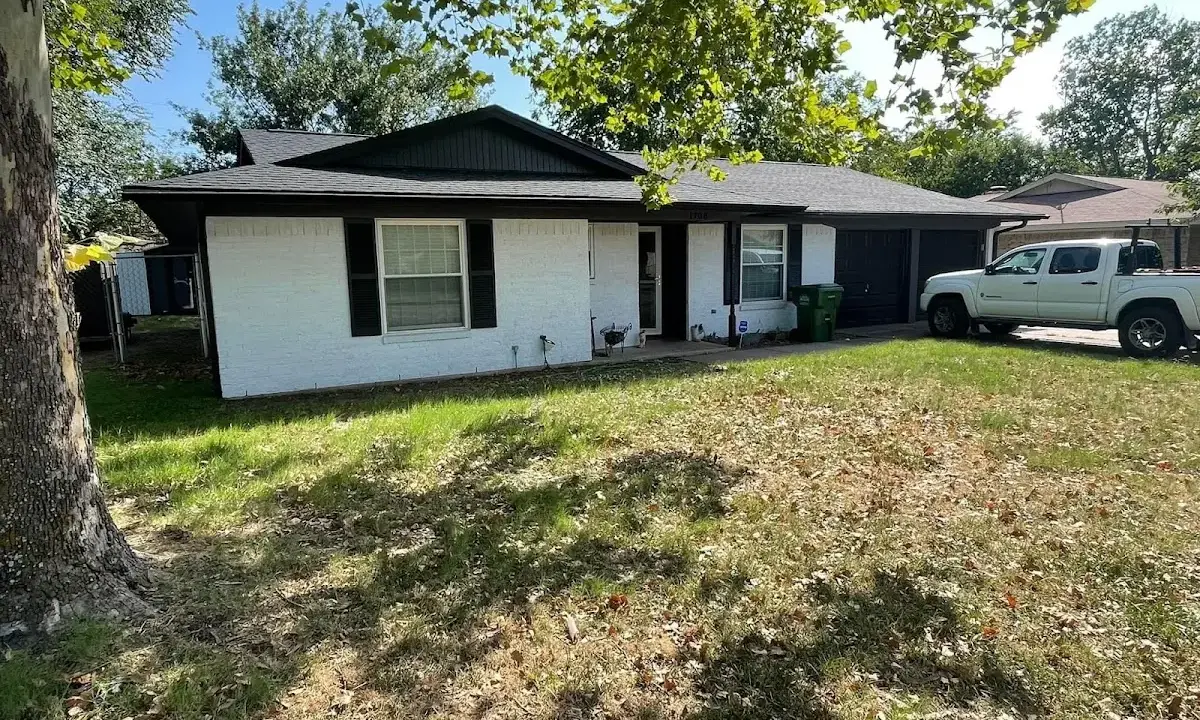 Professional roofing crew working on a residential roof in Rockwall